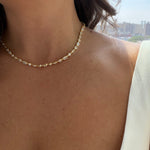 multi stone modern tennis necklace in gold style on a close up of a woman neck. waterproof and hypoallergenic demi fine jewelry