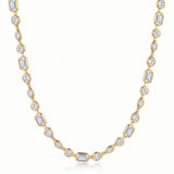 A yellow gold tennis necklace featuring baguette, round, marquise, and teardrop-cut clear gemstones, displayed on a clean white background.