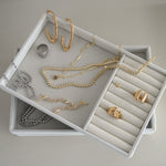 Large gold elongated hoop earrings styled in ear stack with studs and ear cuff – Nikki E. Designs