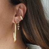 Large gold elongated hoop earrings styled in ear stack with studs and ear cuff – Nikki E. Designs