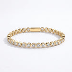 Waterproof Mini Remi bezel-set CZ tennis bracelet in gold surgical stainless steel on white background – Nikki E. Designs