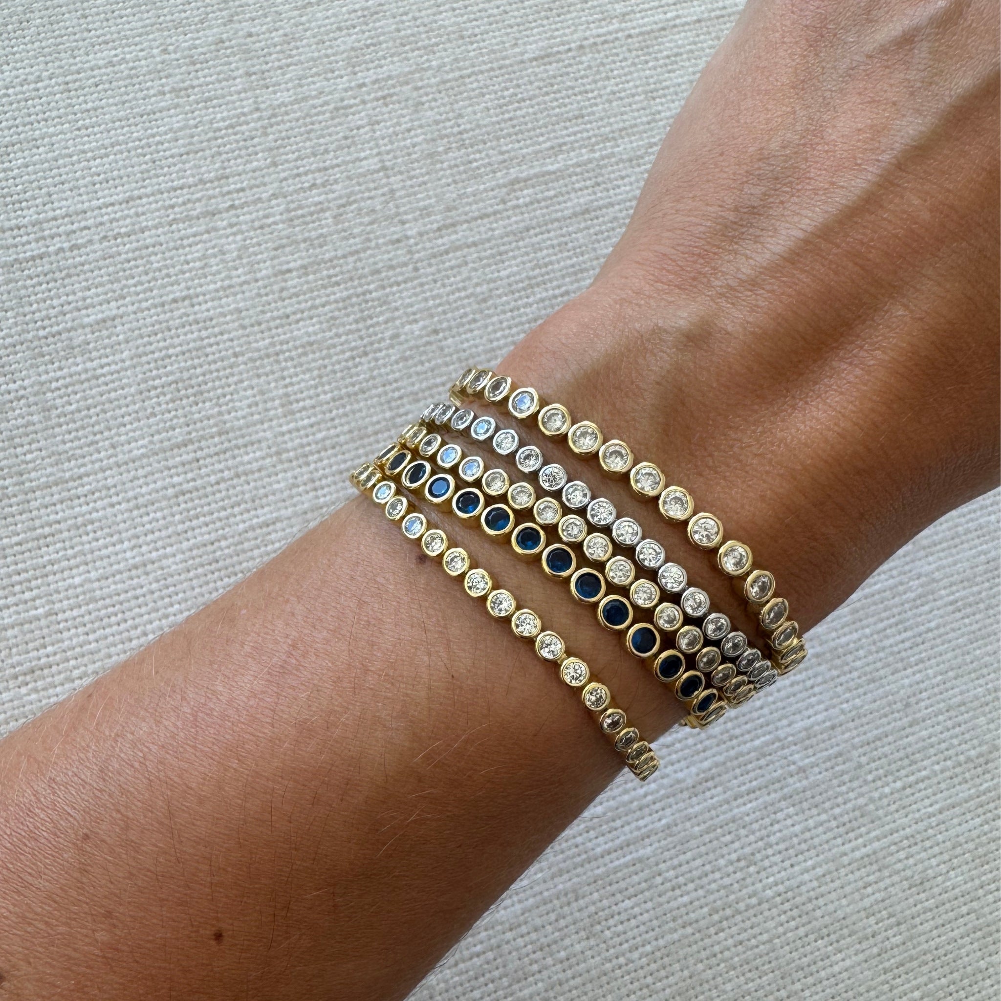 Waterproof Gold and silver bezel CZ tennis bracelets stacked six deep on wrist – Nikki E. Designs
