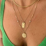 Gold coin necklace layered with cuban curb chain and tag pendant with green top – Nikki E. Designs