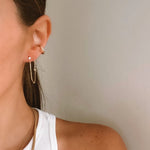 Gold satellite chain threader earrings worn through two piercings in ear stack – Nikki E. Designs